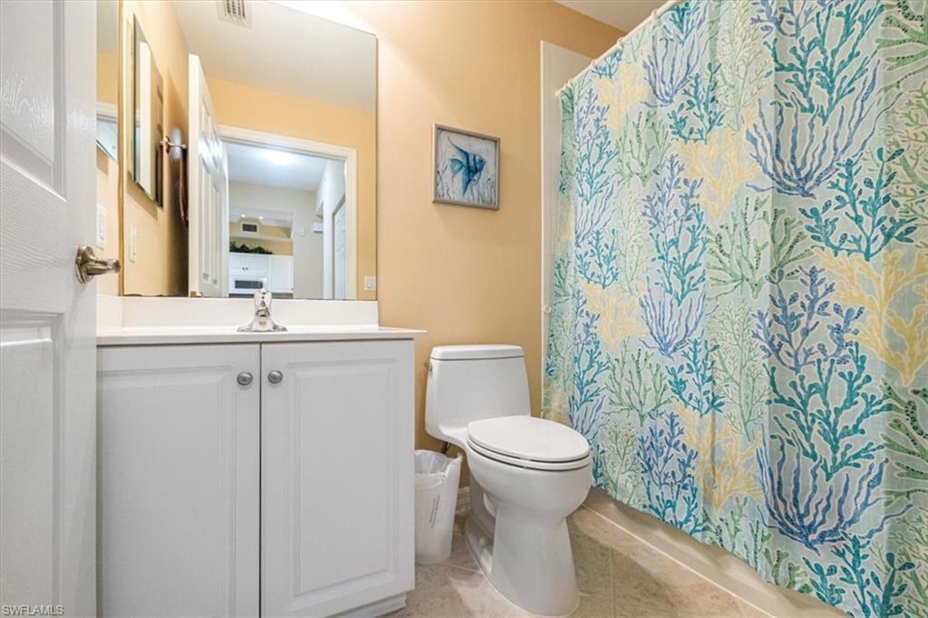 Full bath featuring vanity and light tile patterned floors