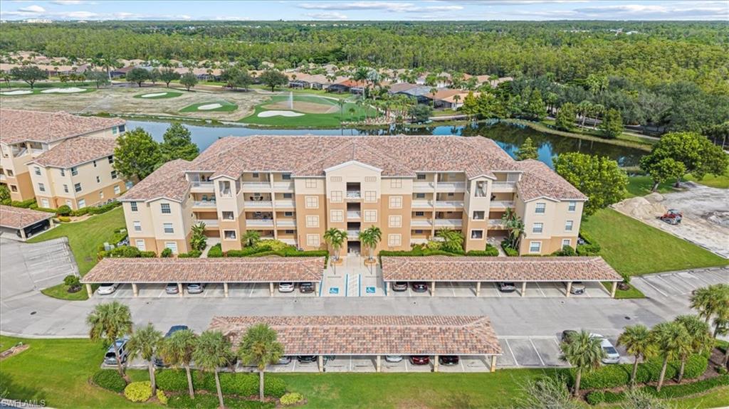Drone / aerial view of apartment complex and a large body of water