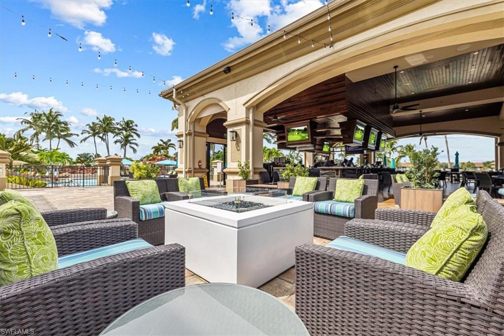 View of patio with an outdoor living space with a fire pit and outdoor dining space