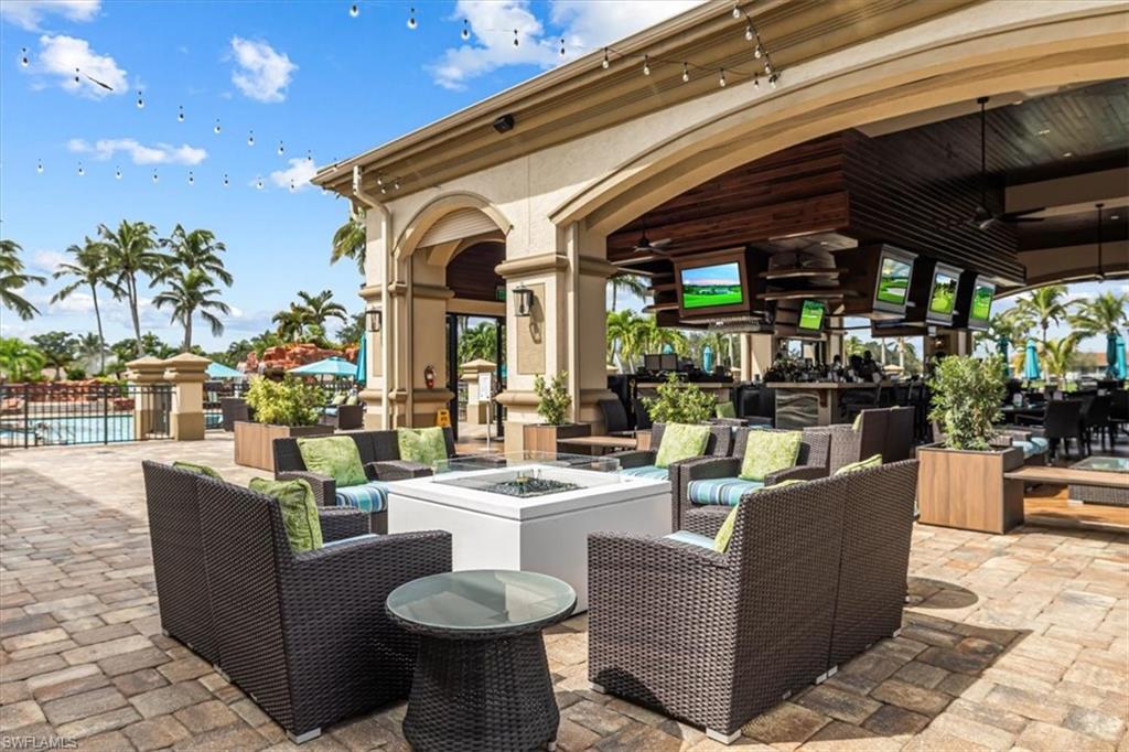 View of patio with a ceiling fan, an outdoor living space with a fire pit, and an outdoor pool