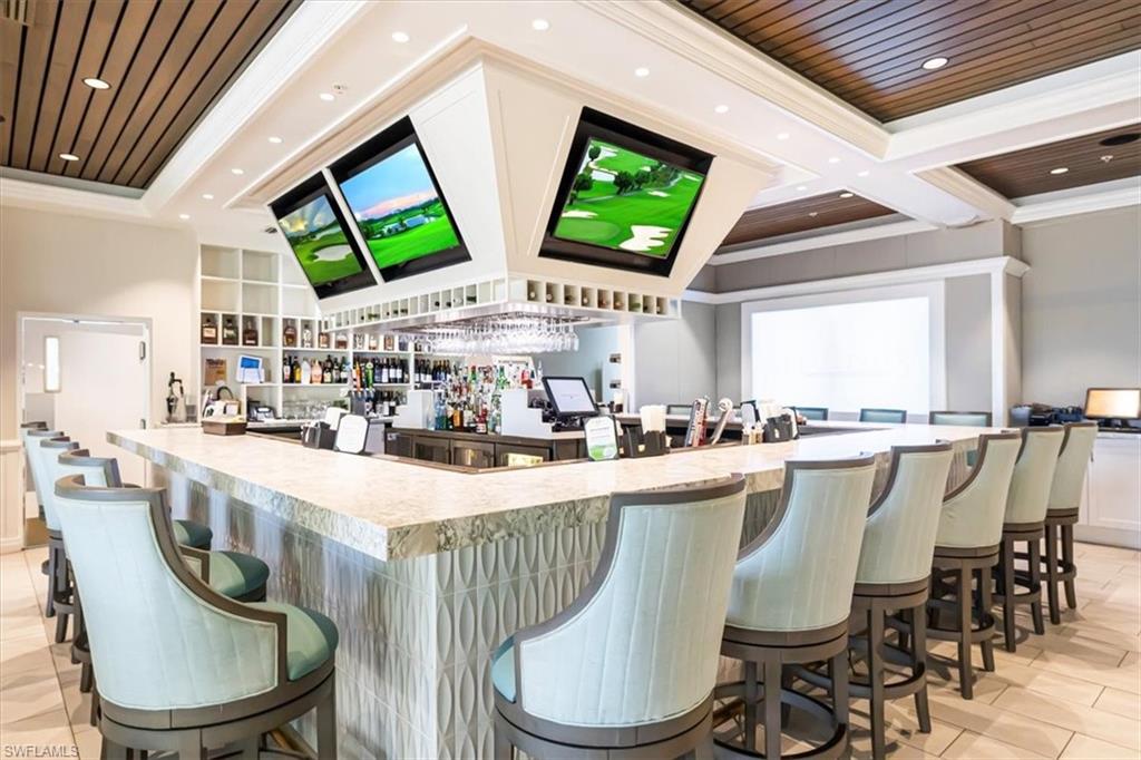 Community bar area featuring light countertops, ornamental molding, light tile patterned flooring, recessed lighting, and wooden ceiling