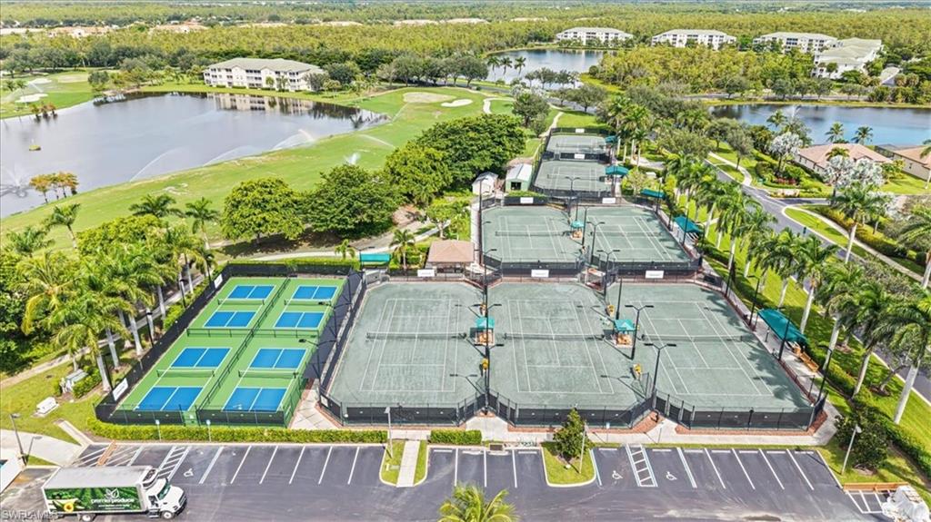 Aerial view of property's location featuring a nearby body of water and a local golf course