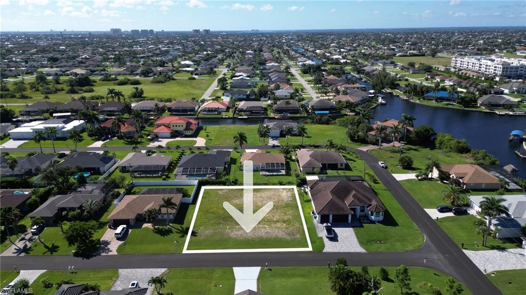 Aerial overview of property's location featuring a large body of water and property boundaries highlighted