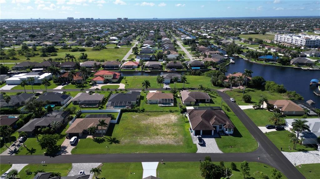 Aerial view of property and surrounding area featuring a nearby body of water