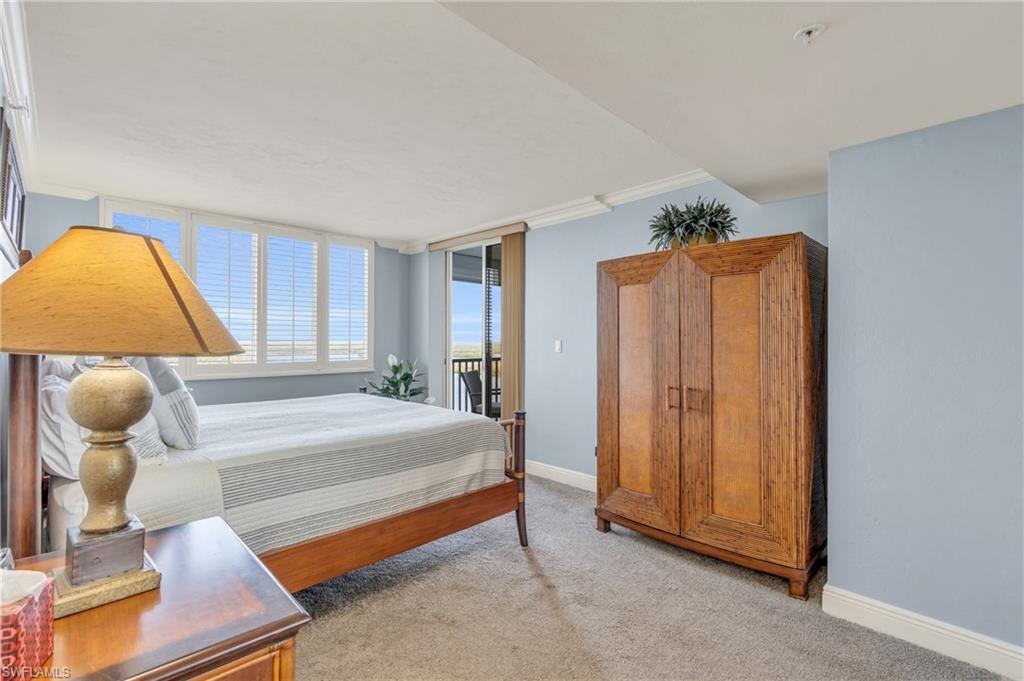 Carpeted bedroom with crown molding / virtually enhanced image