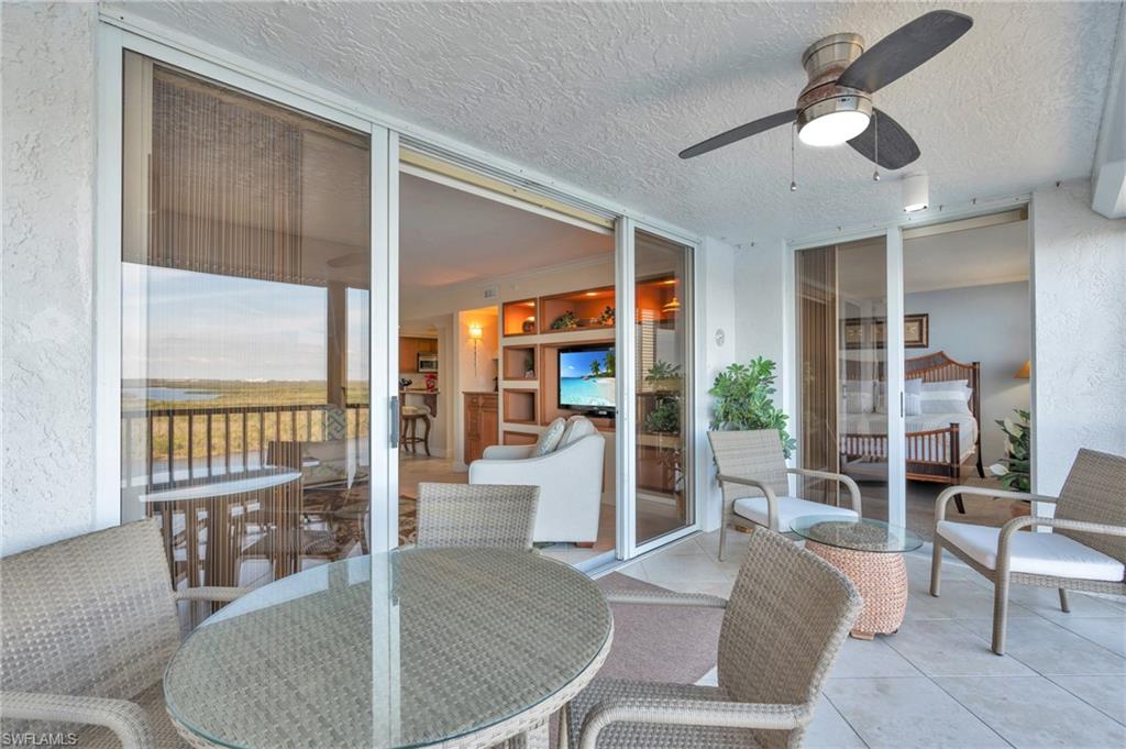 Sunroom with ceiling fan / virtually enhanced image