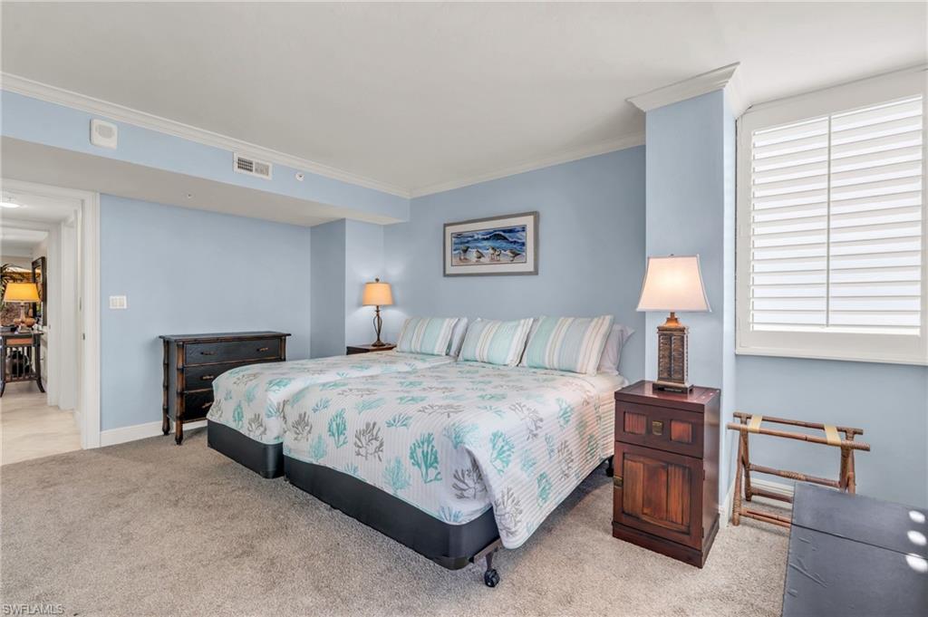 Bedroom featuring light carpet and crown / molding / vrtually enhanced image