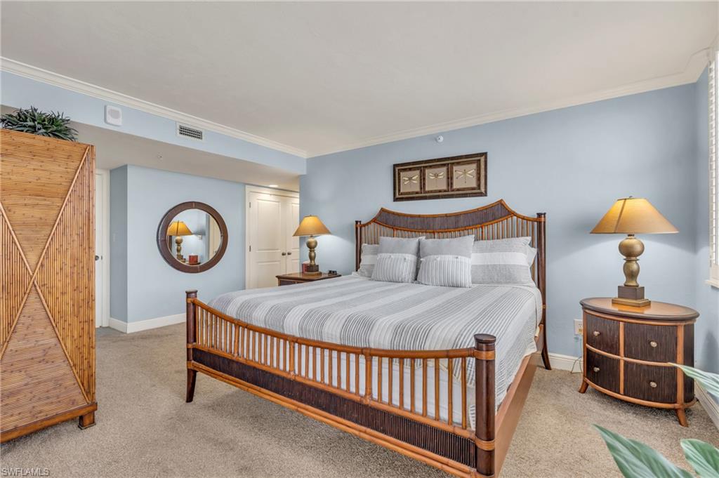 Carpeted bedroom featuring ornamental molding / virtually enhanced image