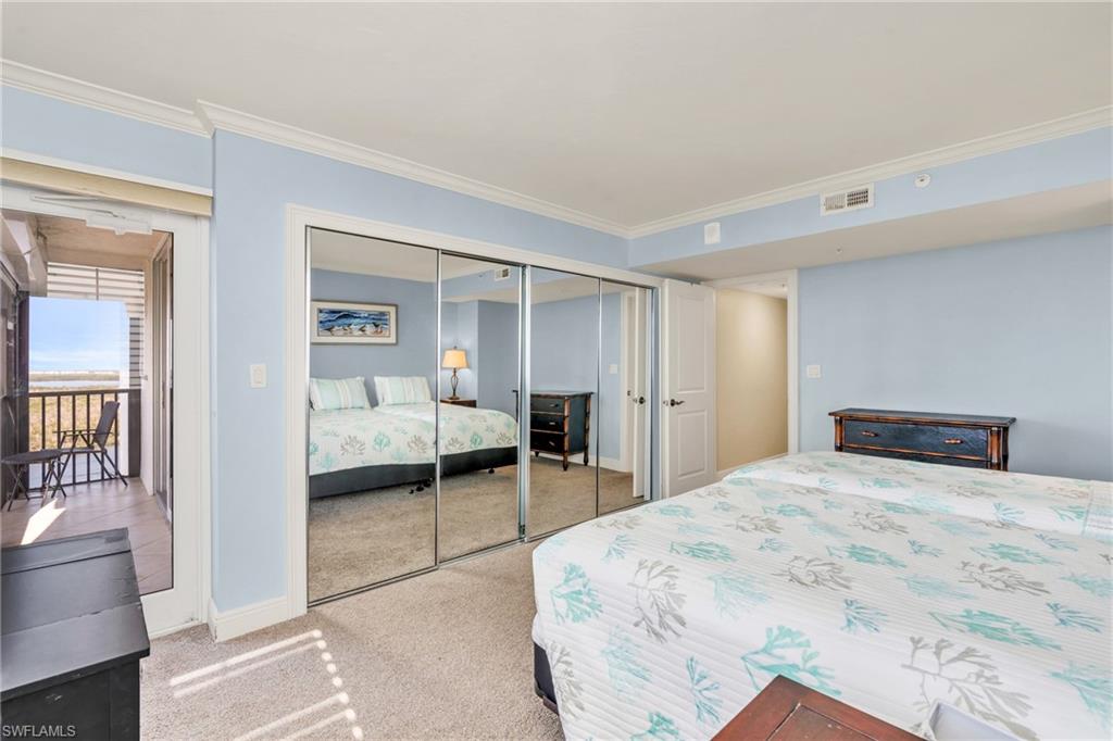 Carpeted bedroom featuring crown molding / virtually enhanced image