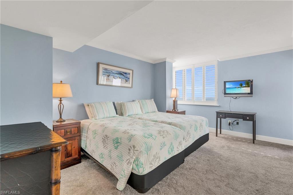 Carpeted bedroom featuring crown molding / virtually enhanced image