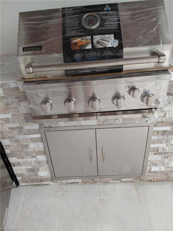 Detailed view of light countertops and gray cabinetry