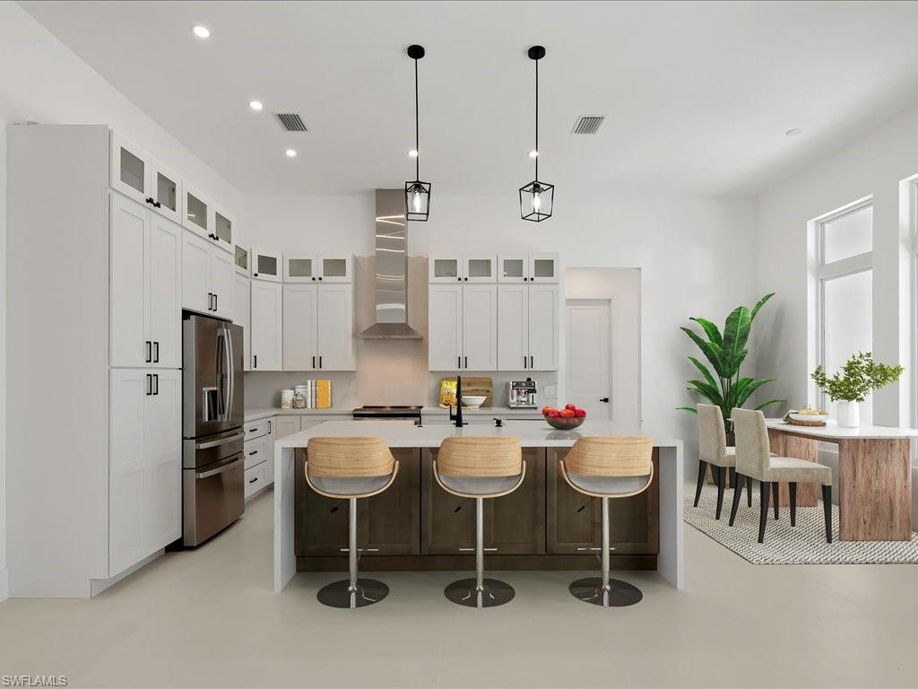 Virtually Staged-Kitchen with stainless steel fridge, glass insert cabinets, decorative light fixtures, a breakfast bar, and light stone countertops