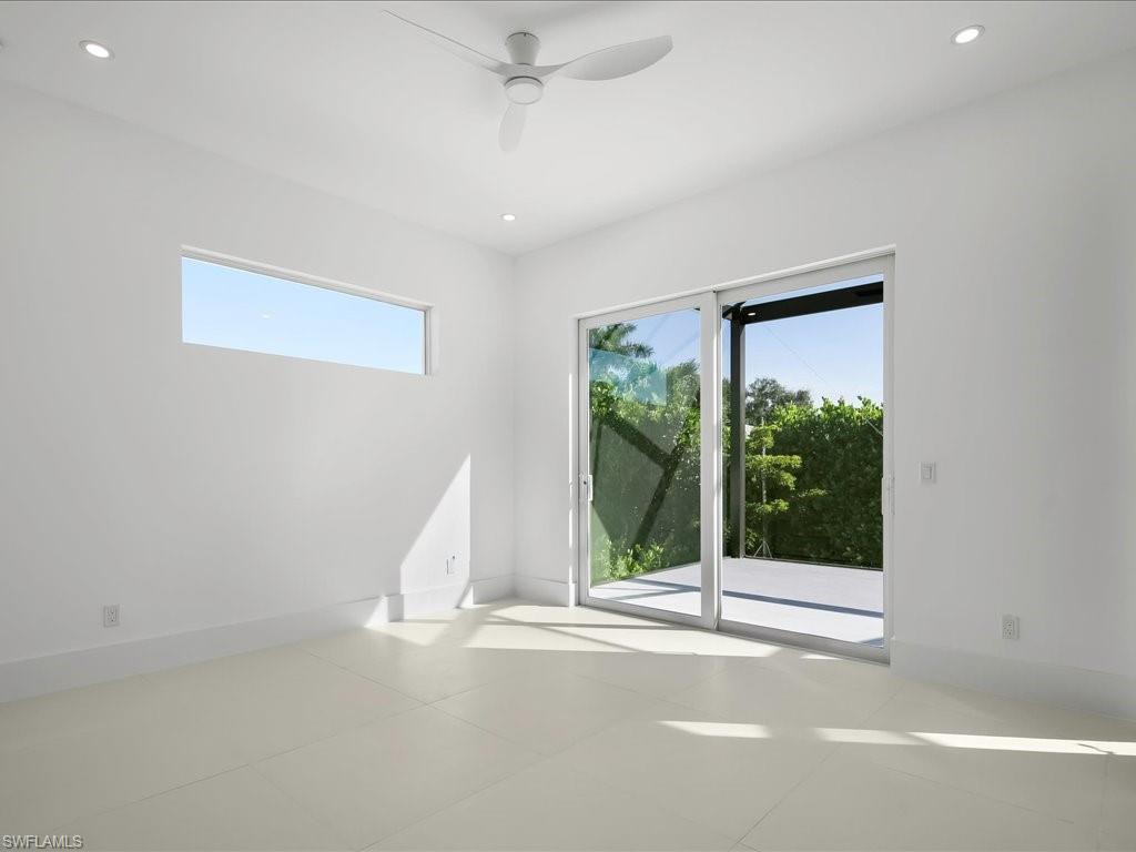 Tiled empty room with recessed lighting and a ceiling fan