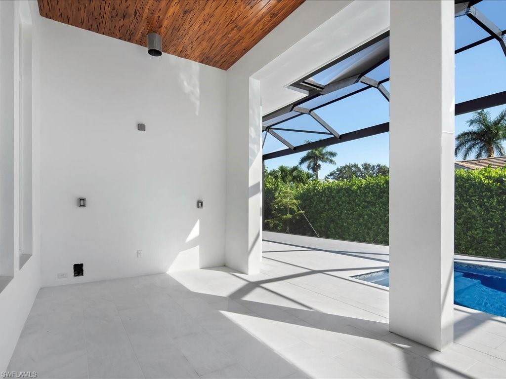 View of patio / terrace featuring an outdoor pool and a lanai