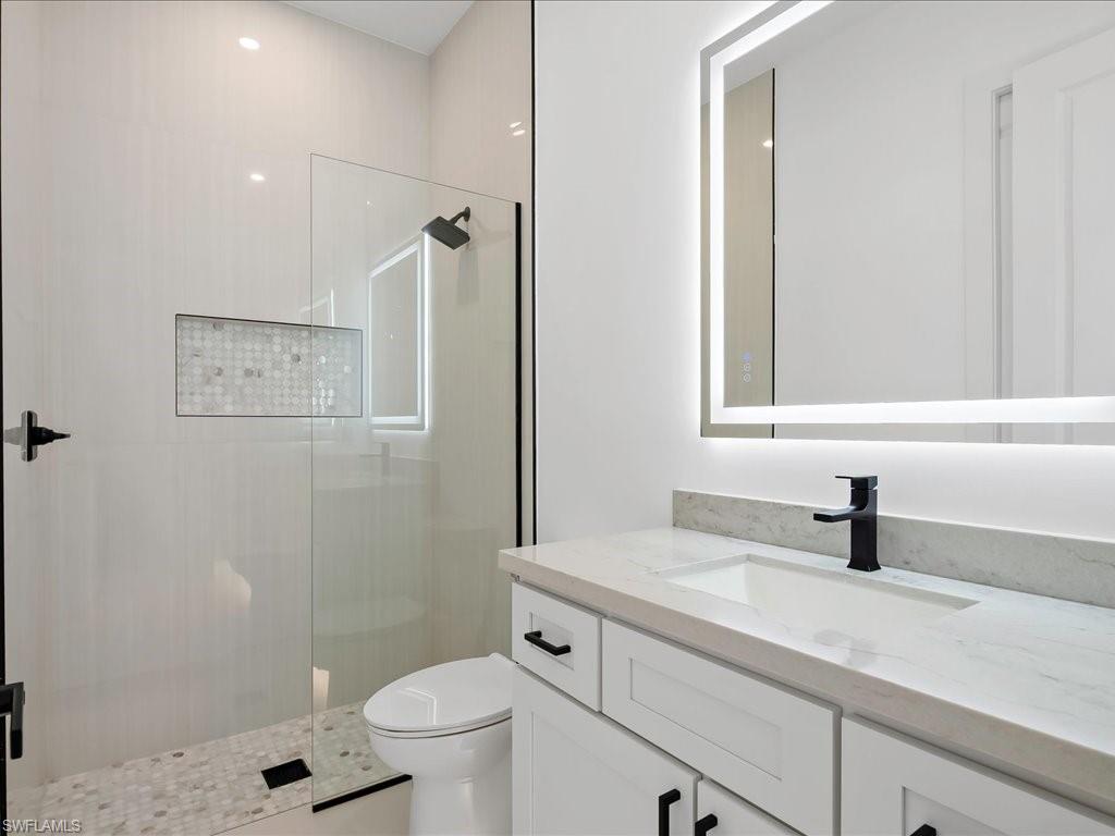 Full bathroom featuring vanity and a shower stall