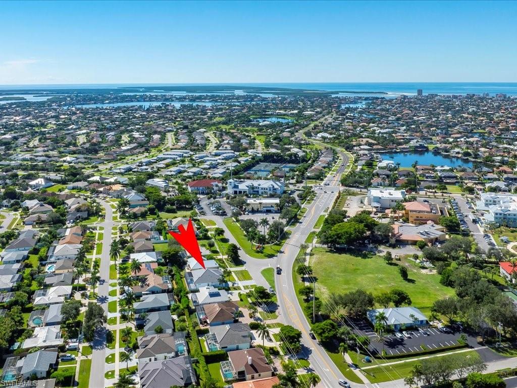 View of property location featuring a large body of water and nearby suburban area