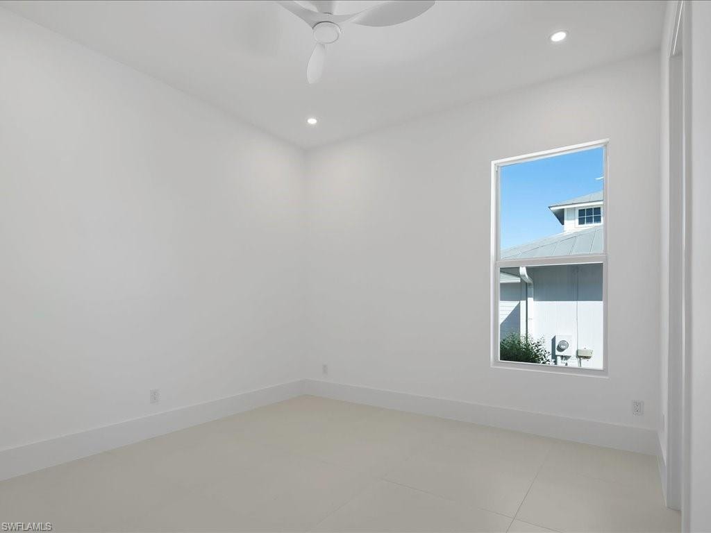 Spare room featuring recessed lighting, light tile patterned floors, and ceiling fan