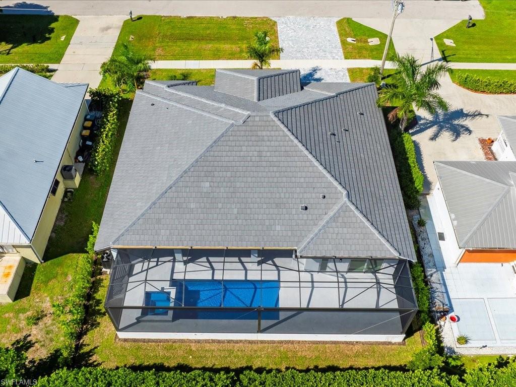 Aerial view of property and surrounding area featuring a pool area