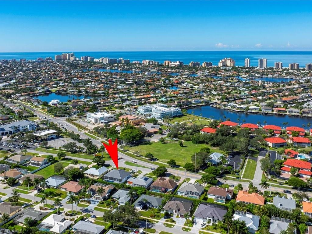 View of property location featuring a nearby body of water and nearby suburban area