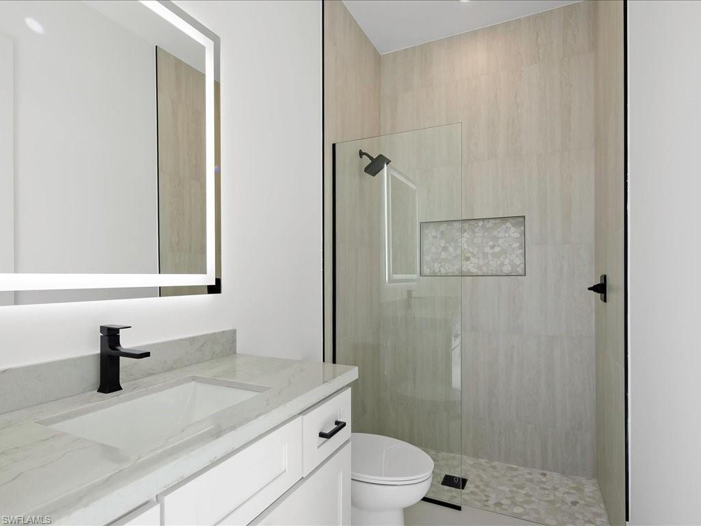 Bathroom featuring walk in shower and vanity