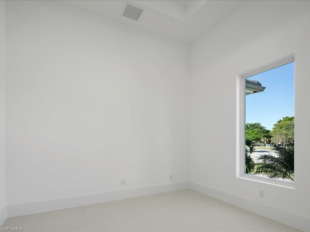 Unfurnished room with baseboards and light tile patterned floors
