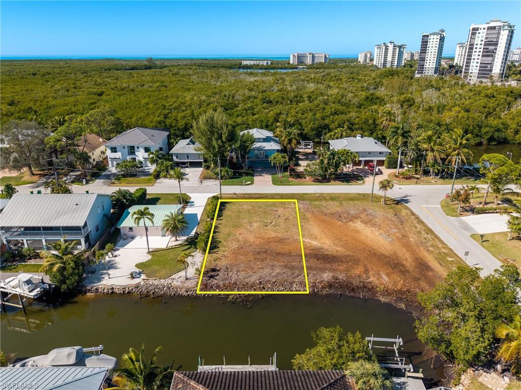 Aerial view of property's location featuring a nearby body of water and property boundaries highlighted