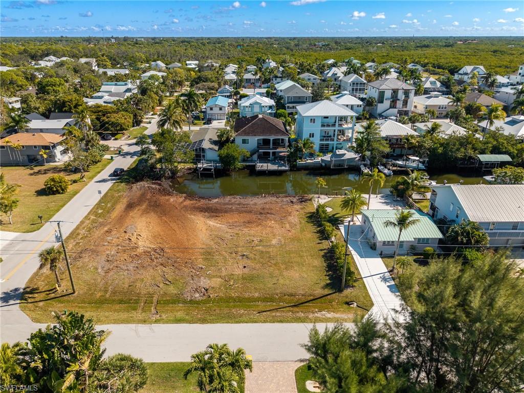 Aerial perspective of suburban area with a nearby body of water