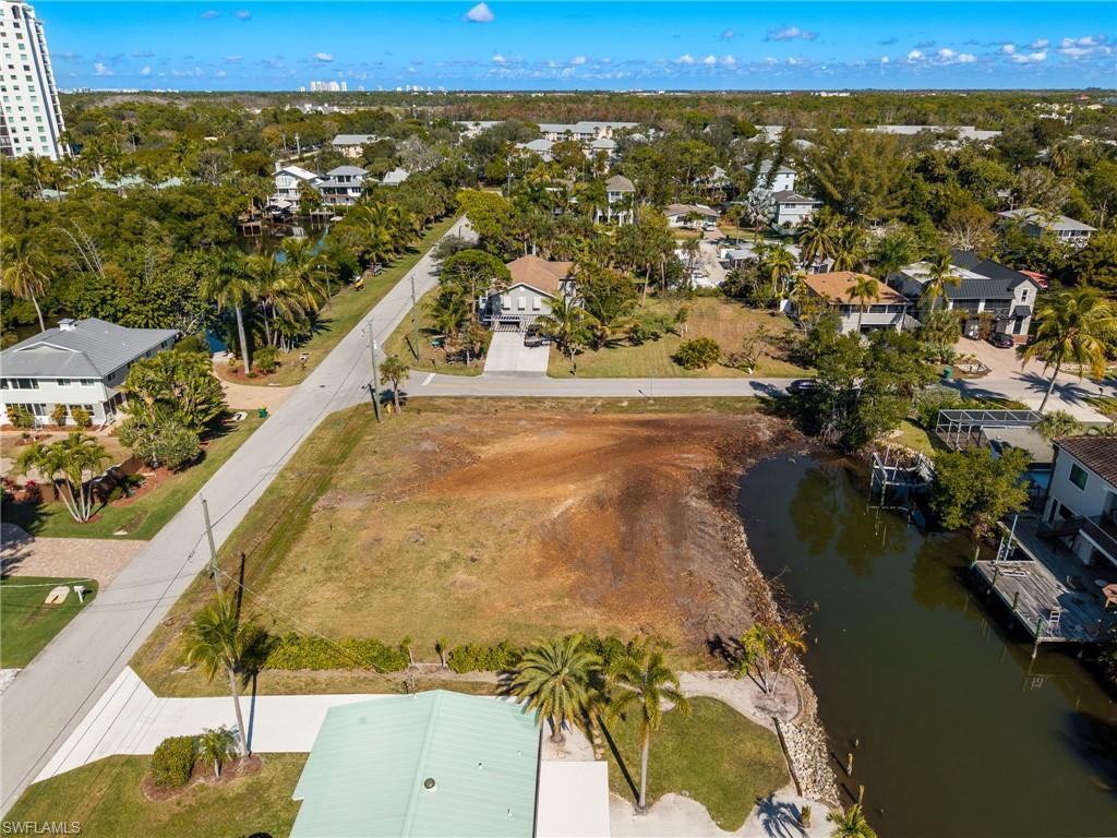 Aerial view of a nearby body of water and a tree filled landscape