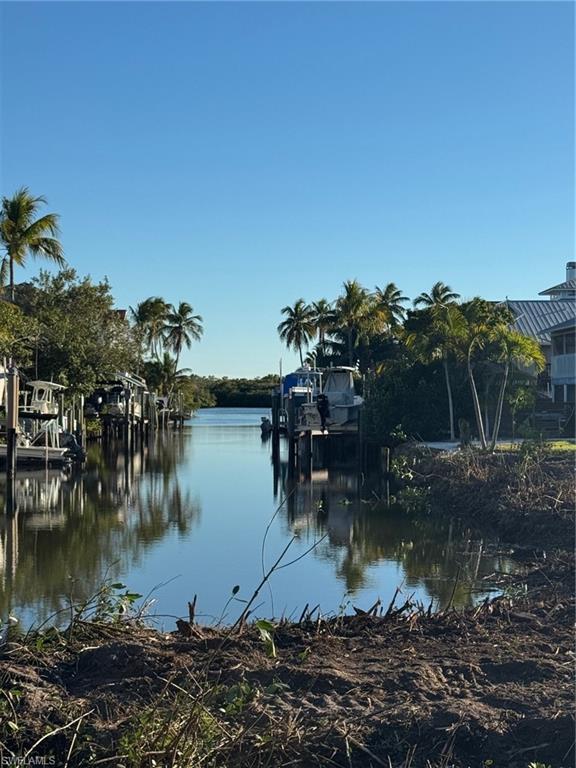 Dock featuring boat lift and a water view