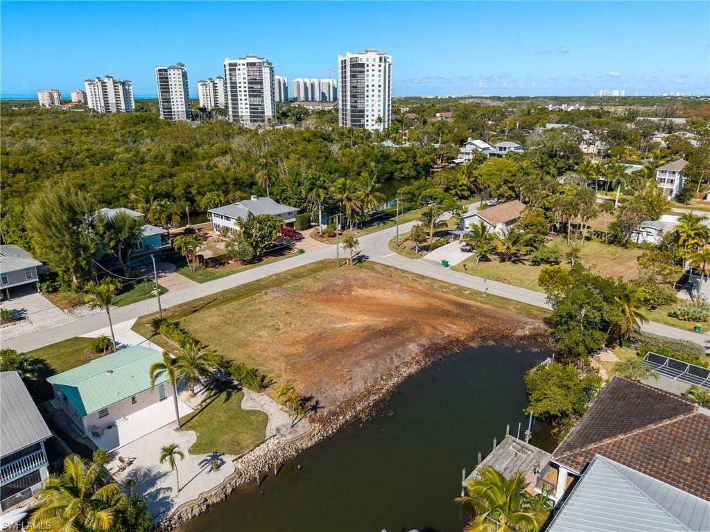 View of urban area with a large body of water and a tree filled landscape