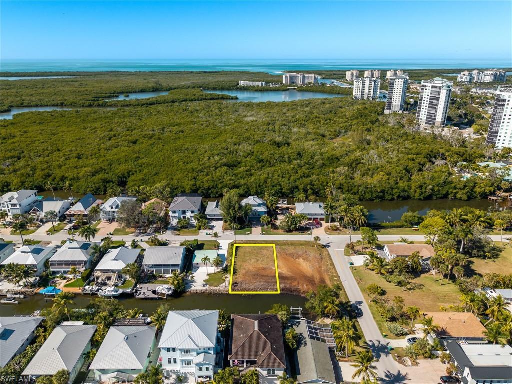 Aerial view of property and surrounding area featuring a nearby body of water