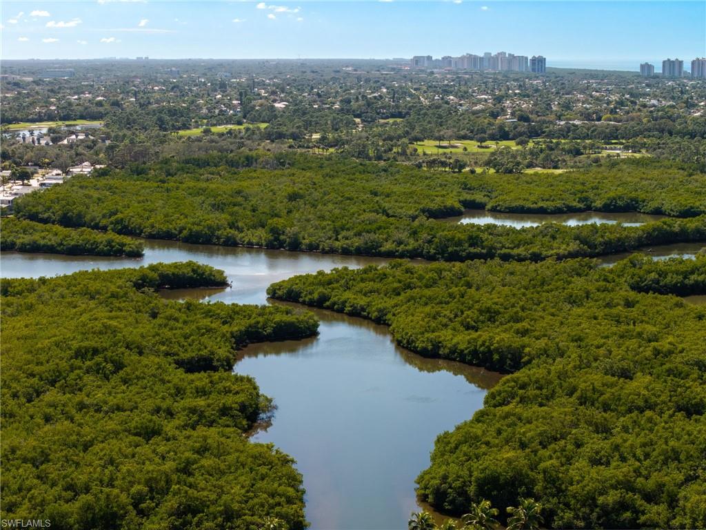 Bird's eye view of a nearby body of water and a heavily wooded area