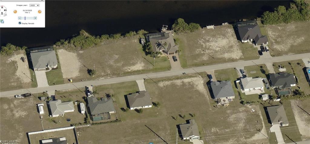 Aerial view of property's location featuring nearby suburban area