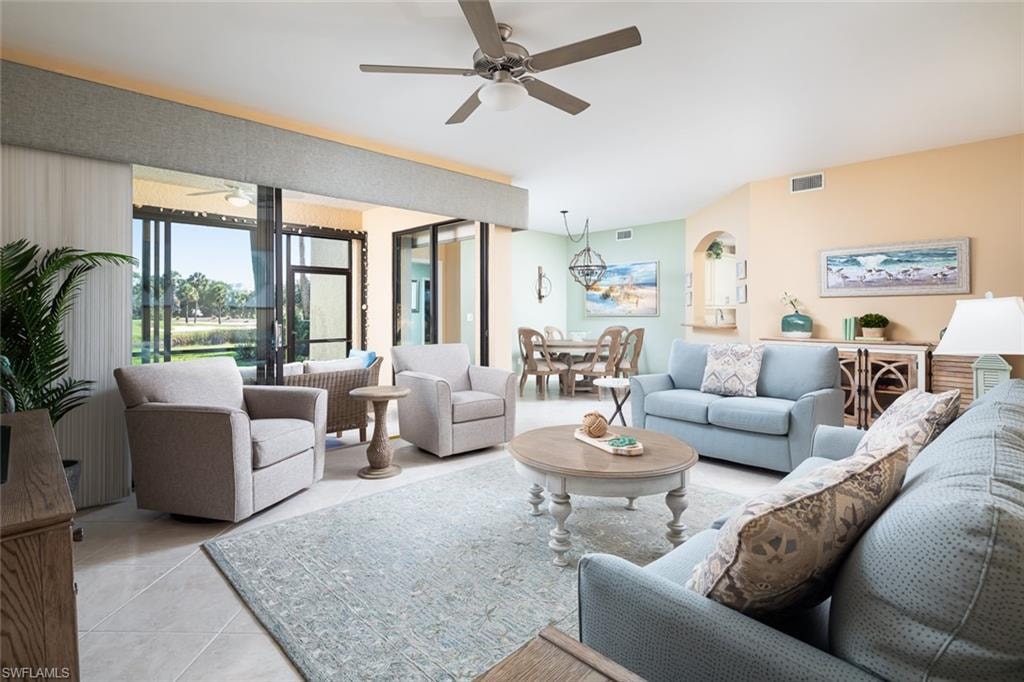 Living room featuring visible vents, ceiling fan, and light tile patterned flooring