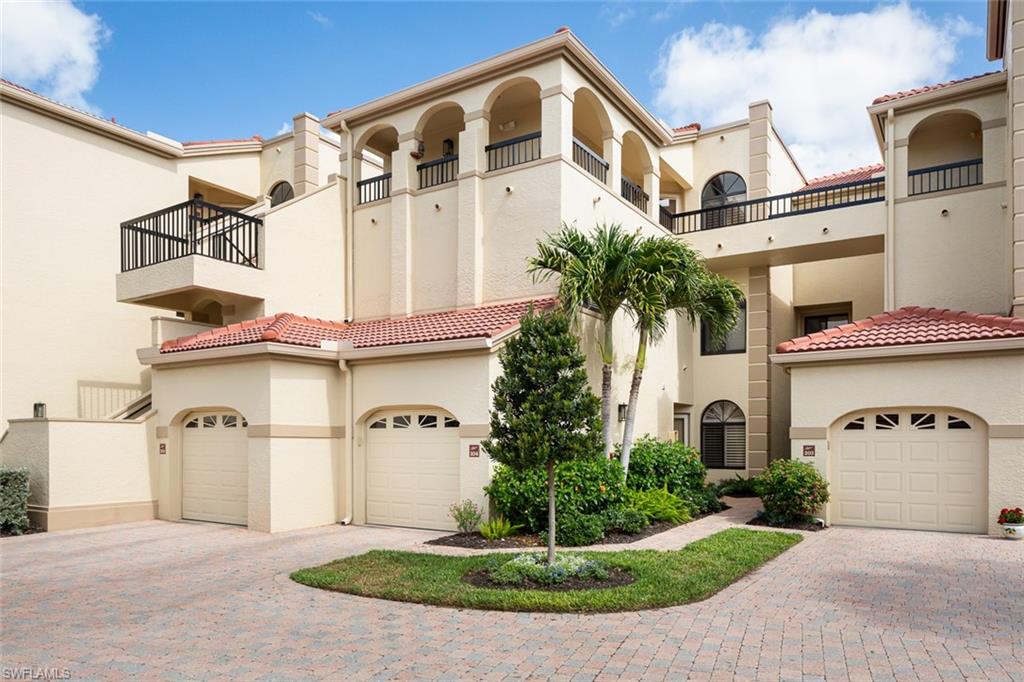 Mediterranean / spanish house with stucco siding, a tiled roof, decorative driveway, a balcony, and an attached garage