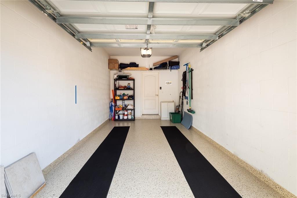 Garage with concrete block wall and a garage door opener