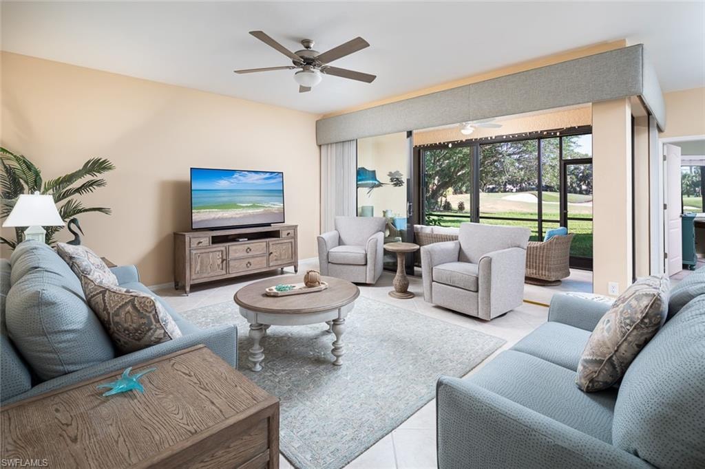 Living room with tile patterned flooring and a ceiling fan
