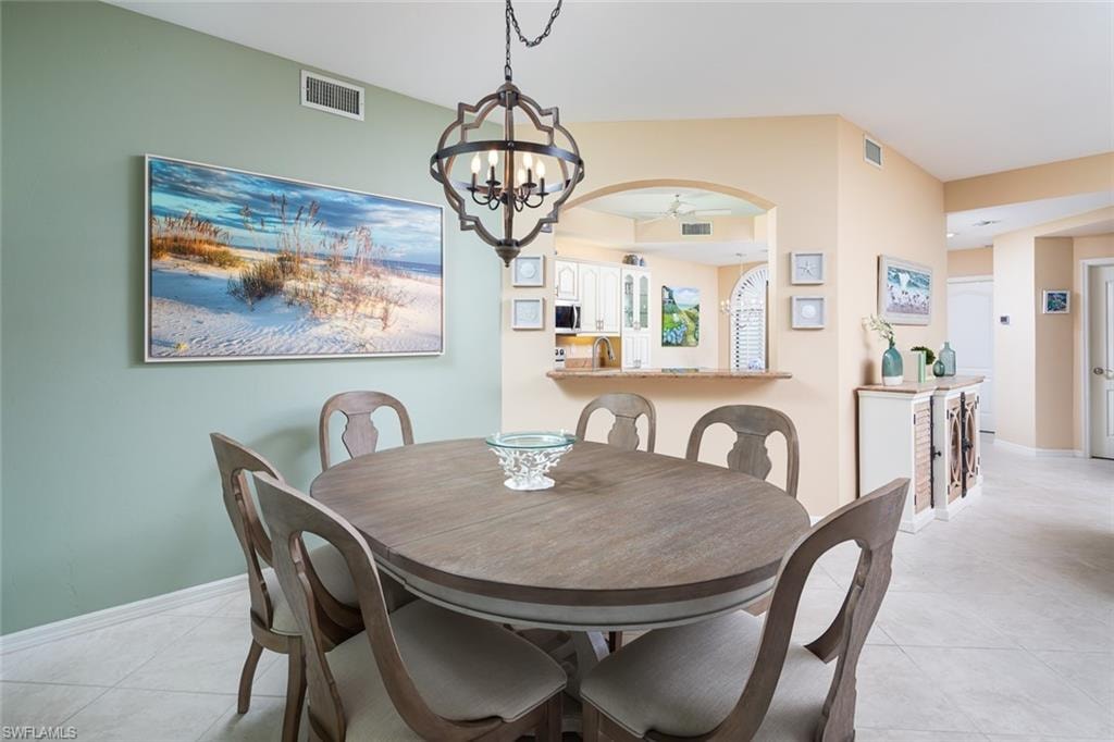 Dining space featuring light tile patterned floors, visible vents, and baseboards