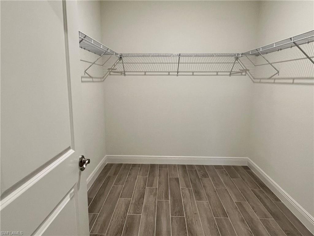 Walk in closet featuring wood tiled floors