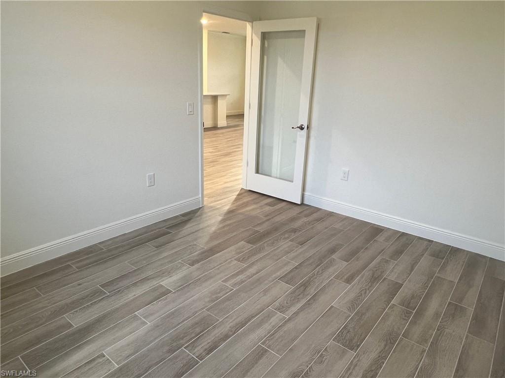 Spare room featuring wood finish floors and baseboards