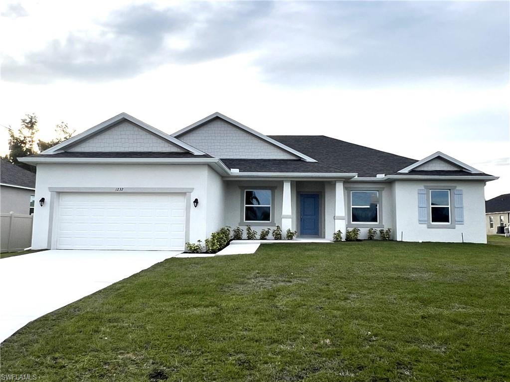 View of front of property featuring a front lawn, stucco siding, a garage, and concrete driveway