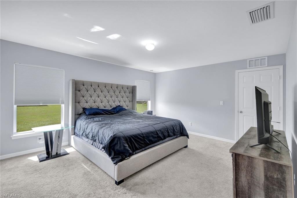 Bedroom with carpet and baseboards
