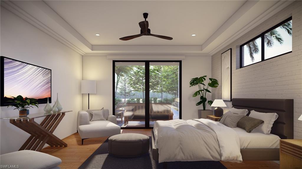 Bedroom with wood finished floors, a raised ceiling, ceiling fan, and access to exterior