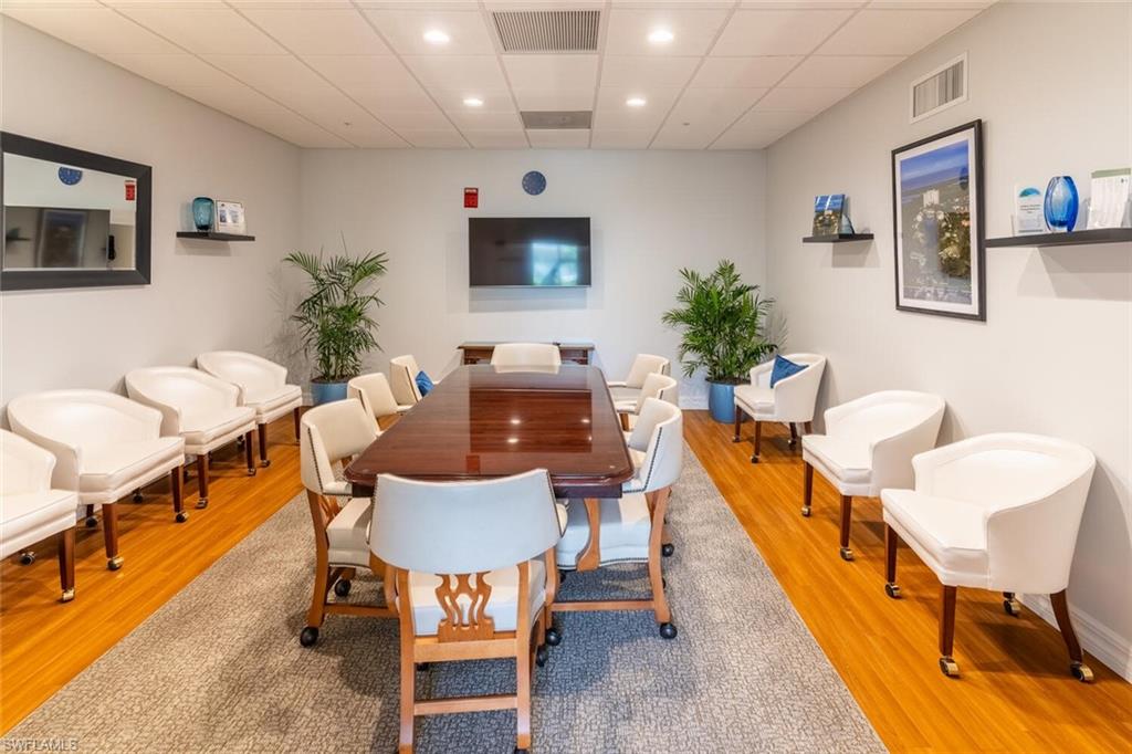 Private dining space featuring a drop ceiling, light wood-style flooring, and recessed lighting