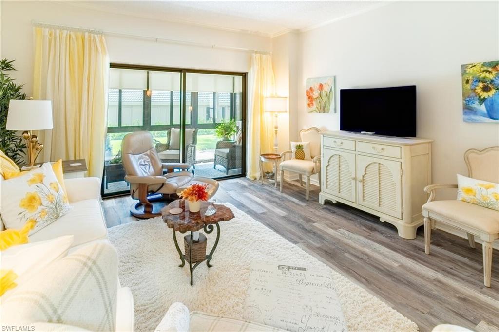 Living room with vinyl wood-like flooring and crown molding