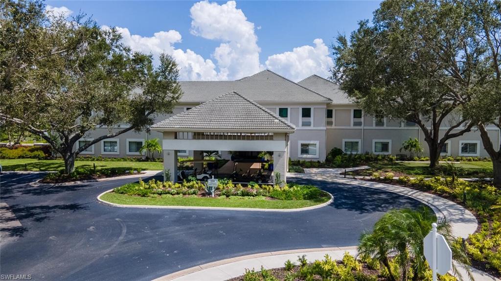 View of property featuring curved driveway