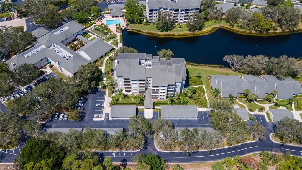 View of property location featuring apartment complex / building and a nearby body of water