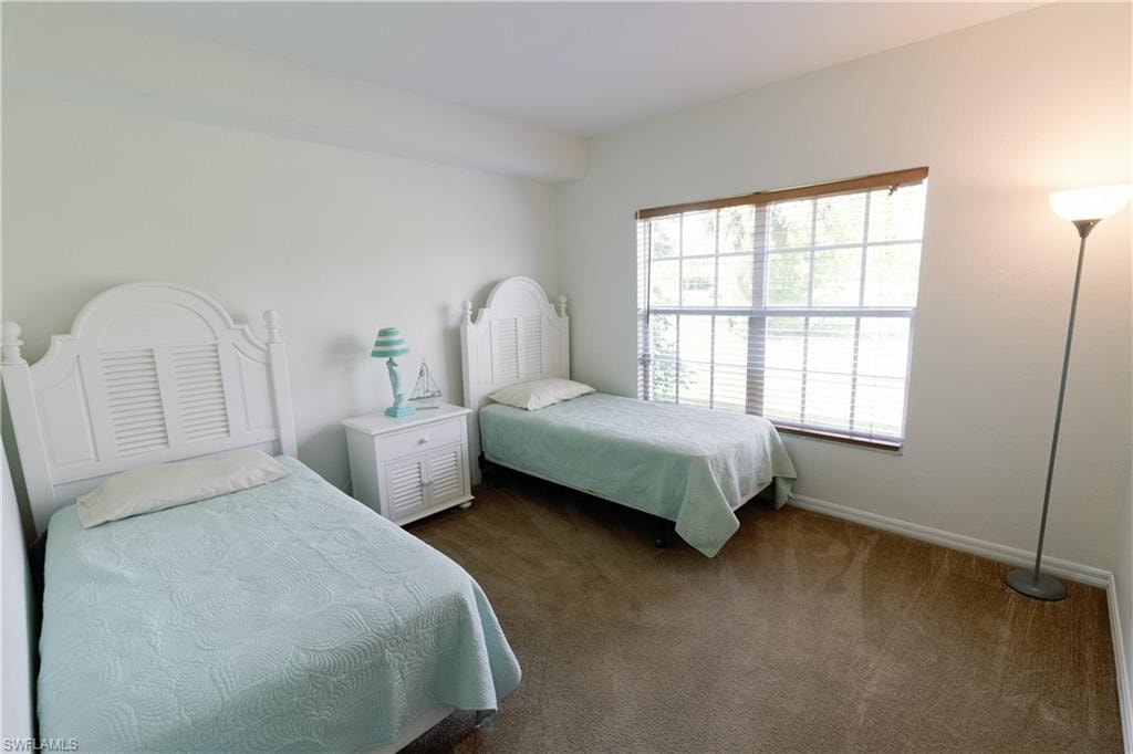 Carpeted bedroom with baseboards