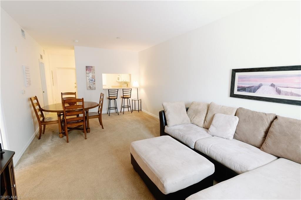 Living room with light colored carpet and baseboards