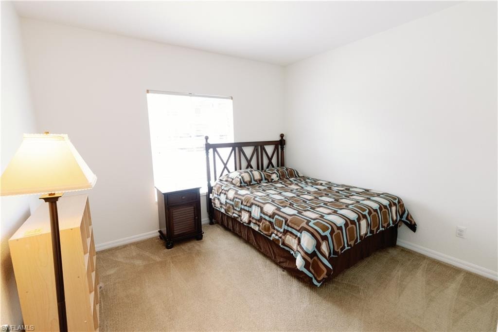 Bedroom with carpet floors and baseboards